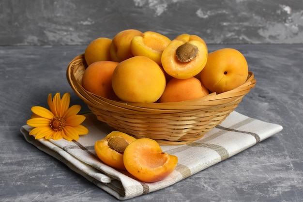 Ripe fruits apricots in a wicker basket summer fruits