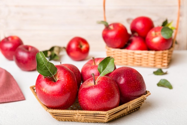 Ripe garden apple fruits with leaves in basket on wooden table Top view flat lay with copy space