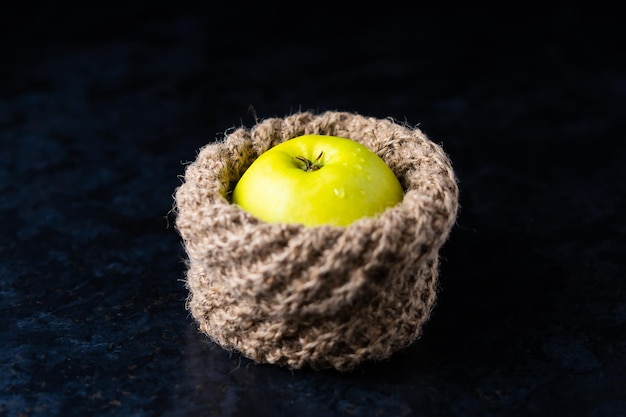 Ripe green apple fruits on dark stone table. Top view with copy space. Flat lay