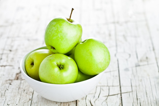 Ripe green apples in bowl