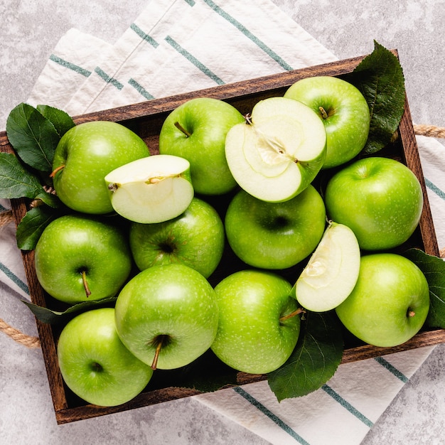 Ripe green apples in wooden box. Top view with copy space.