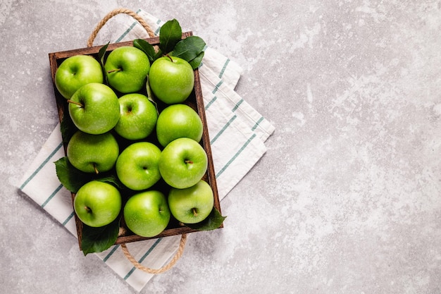 Ripe green apples in wooden box Top view with copy space