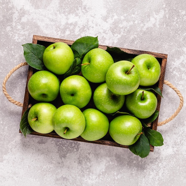 Ripe green apples in wooden box