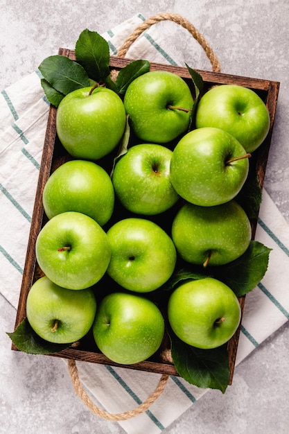 Ripe green apples in wooden box