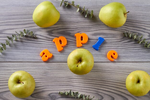 Ripe green apples on wooden grey table