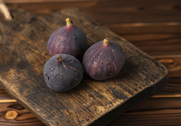 ripe juicy fig on wooden table