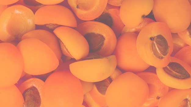 Ripe juicy orange apricots slices fruit background