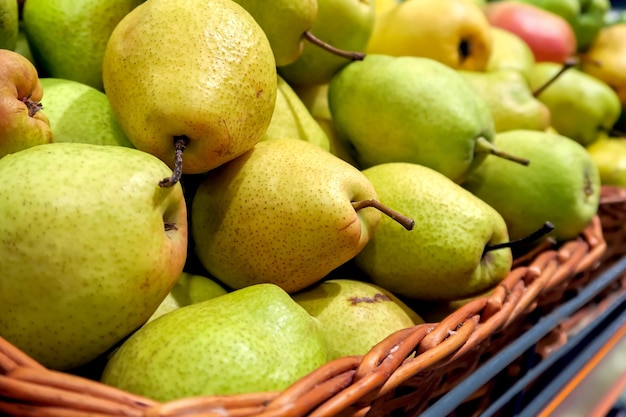 ripe juicy organic yellow pears lie on the counter in the store. healthy vegan food concept