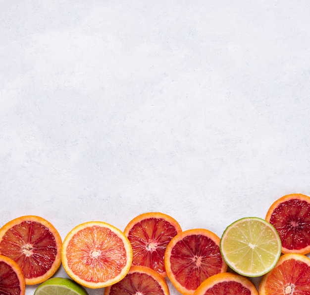 Ripe juicy slices of red oranges on a white background