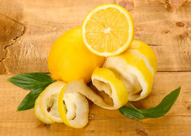 Ripe lemons with leaves on wooden table