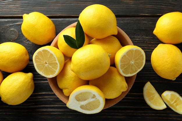 Ripe lemons on wooden, top view