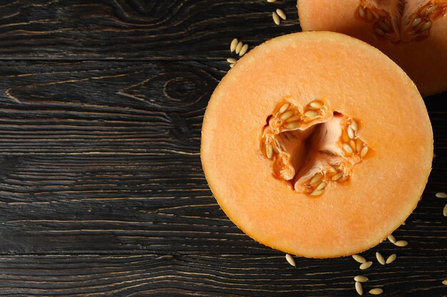 Ripe melon halves on rustic wooden table