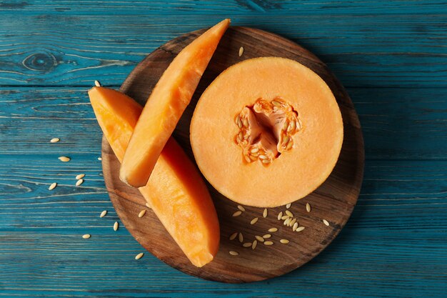 Ripe melon on wooden table, top view