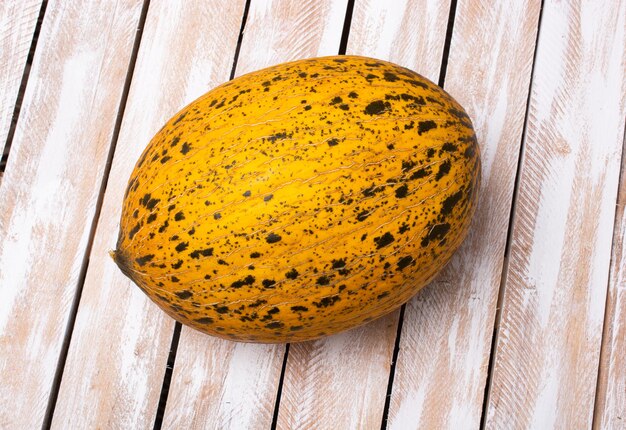 Ripe melons in the farmers market on wooden planks