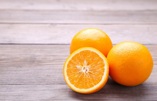 Ripe orange fruit on a grey background