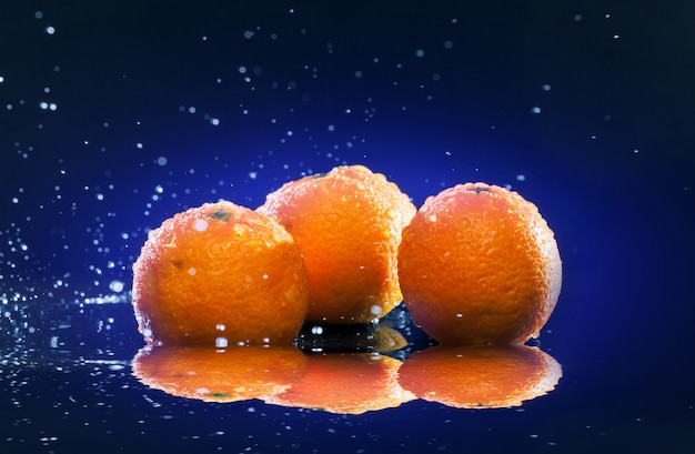 Ripe oranges on mirror