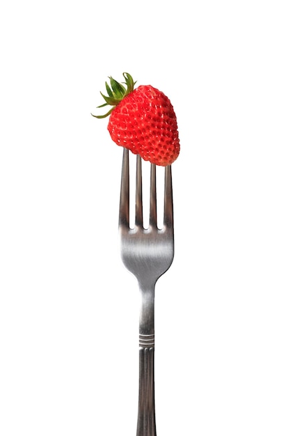 Ripe organic strawberries on a fork The concept of growing organic food