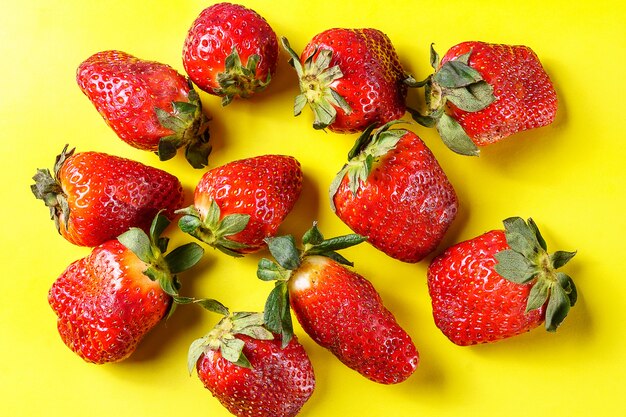 Ripe organic strawberries on wooden background, close up.