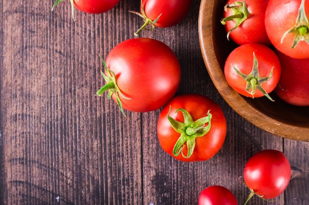 Ripe organic tomatoes on a wooden table Harvest and local products Top view