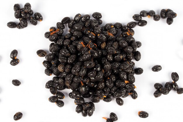 Ripe papaya seeds on white background