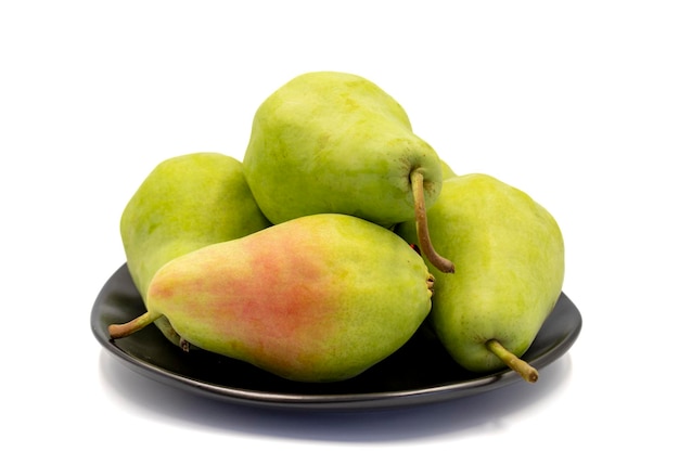 Ripe pear isolated on white background Fresh and juicy pear on the plate Organic food close up