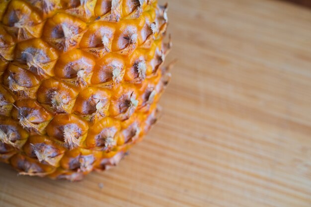 Ripe pineapple on a cutting board.