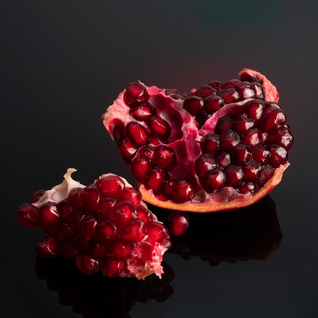 Ripe pomegranate on a dark surface