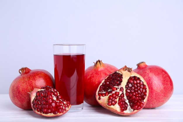 Ripe pomegranate and fruit juice glass