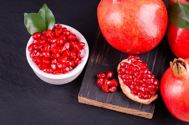 Ripe pomegranate fruits on the wooden background