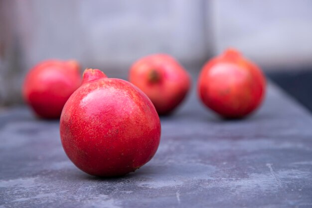 Ripe pomegranates on a slate board Selective focus