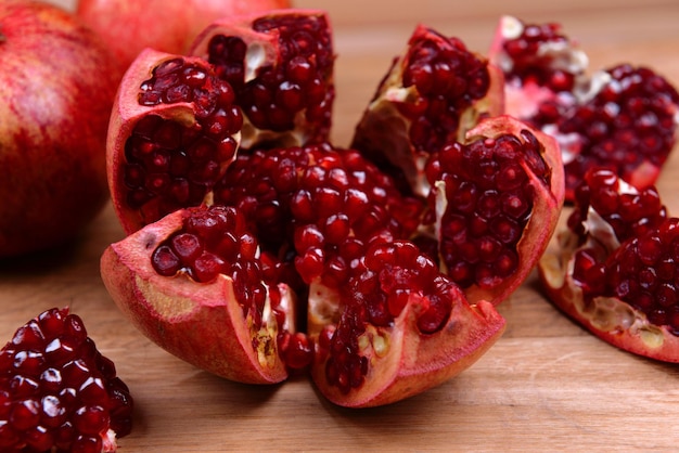 Ripe pomegranates on table closeup