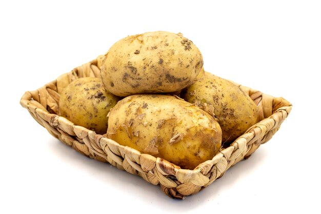 Ripe Potatoes Fresh and raw potatoes in basket isolated on white background Organic food close up