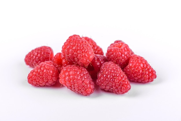 Ripe raspberries with raspberry leaf isolated on a white background