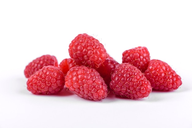 Ripe raspberries with raspberry leaf isolated on a white background