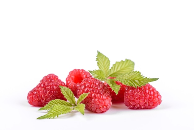 Ripe raspberries with raspberry leaf isolated on a white background