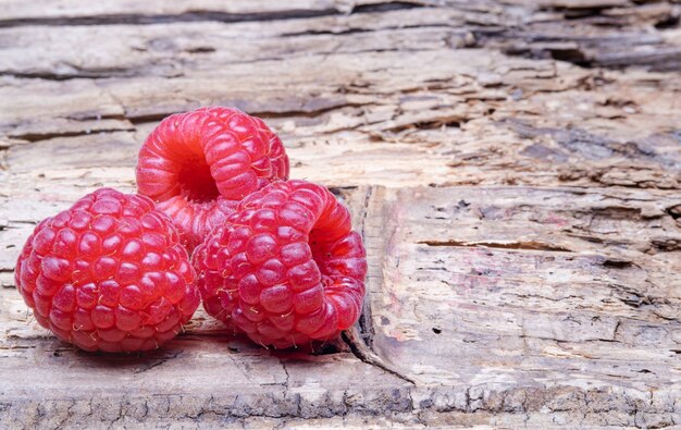 Ripe raspberries on a wooden table