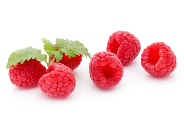 Ripe raspberry with leaf isolated on the white surface.