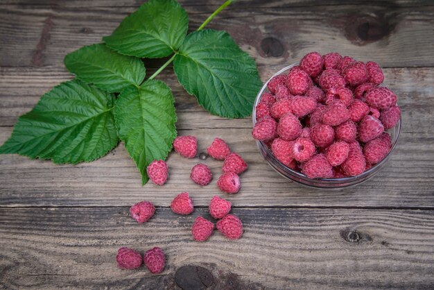 Ripe raspberry on wooden background