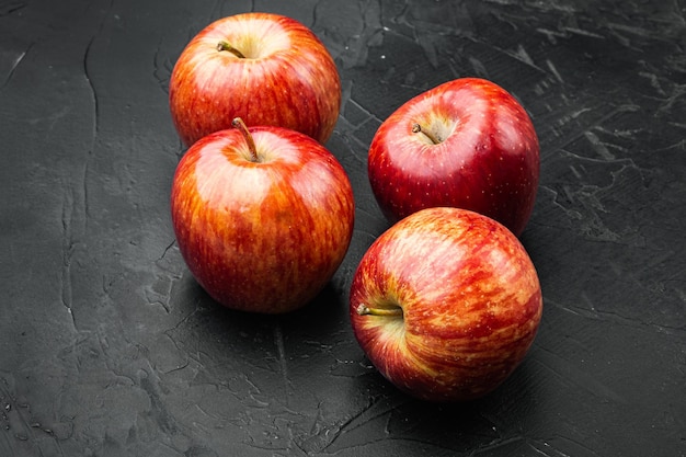 Ripe red apples on black dark stone table background