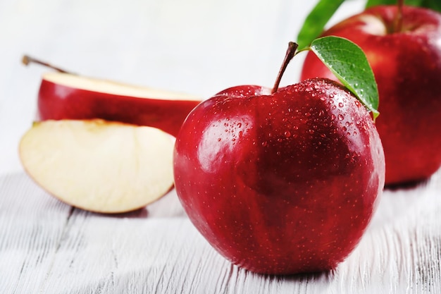 Ripe red apples on table close up