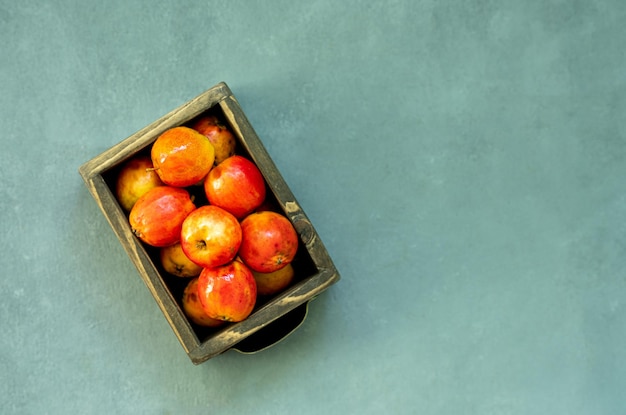 Ripe red apples in wooden box Top view with space for your text