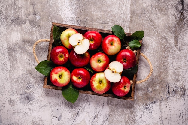 Ripe red apples in wooden box