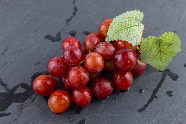 Ripe red grape on the dark background