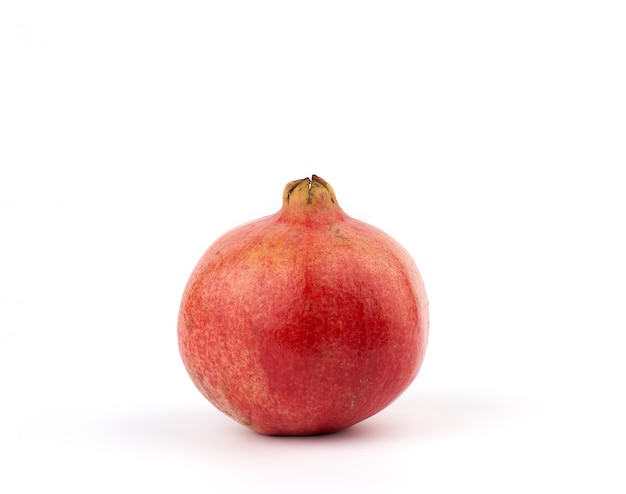 Ripe red pomegranate in a peel on a white background