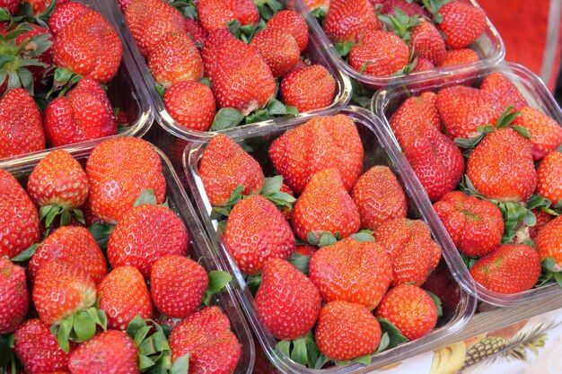 Ripe Red Strawberries in a plastic box on table