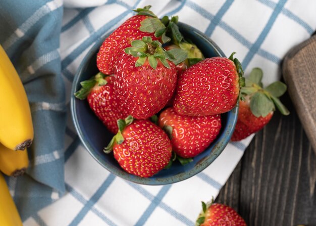 Ripe red strawberries in a plate close up