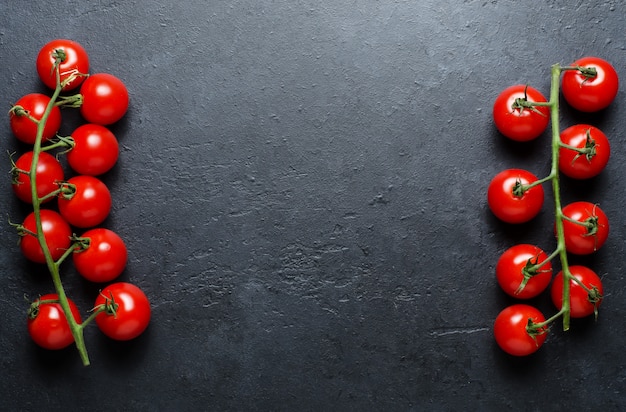 Ripe red tomatoes on a green branch. Vitamin-rich vegetables. 