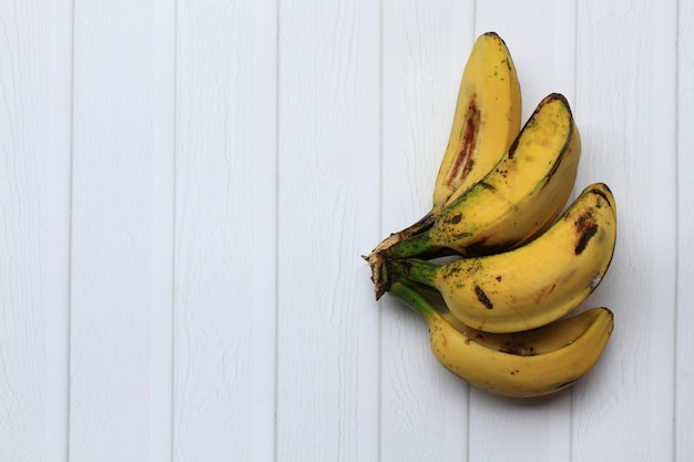 Ripe saba bananas on white background Half composition