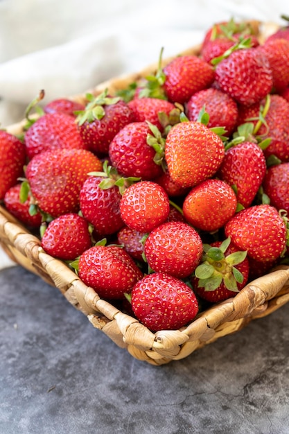 Ripe strawberries on a dark background Fresh strawberries in a basket Organic food close up