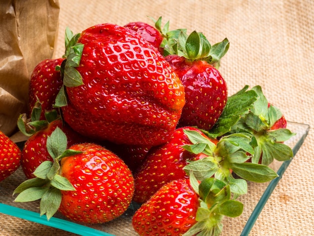 Ripe strawberries on sackcloth closeup